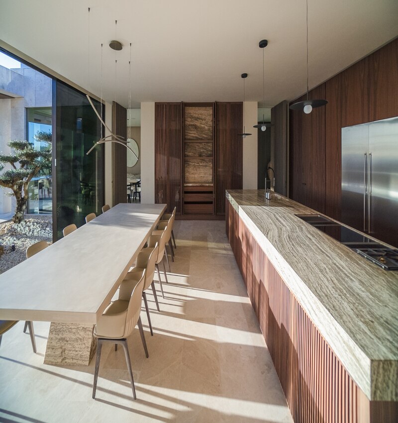 ARK architects elevates villa tai on stone podium framing views of mediterranean sea