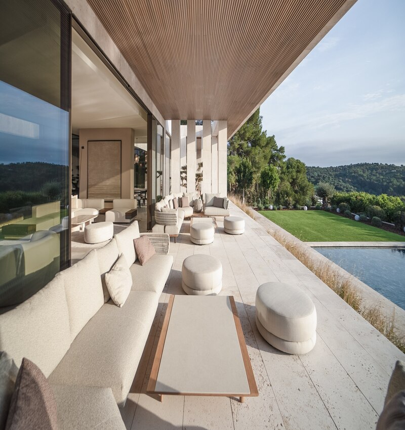 ARK architects elevates villa tai on stone podium framing views of mediterranean sea