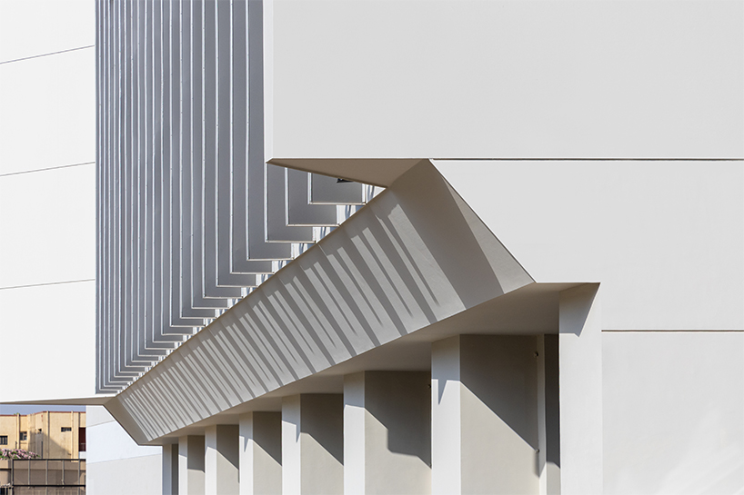 undulating aluminum curtain facade drapes over ain shams university theater in egypt