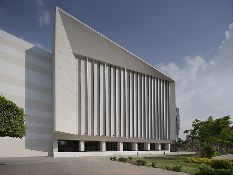 undulating aluminum curtain facade drapes over ain shams university theater in egypt