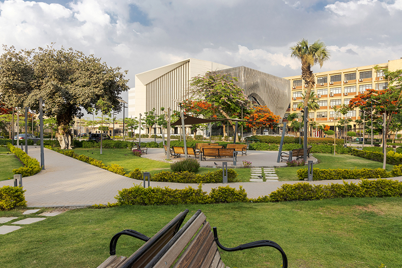 undulating aluminum curtain facade drapes over ain shams university theater in egypt