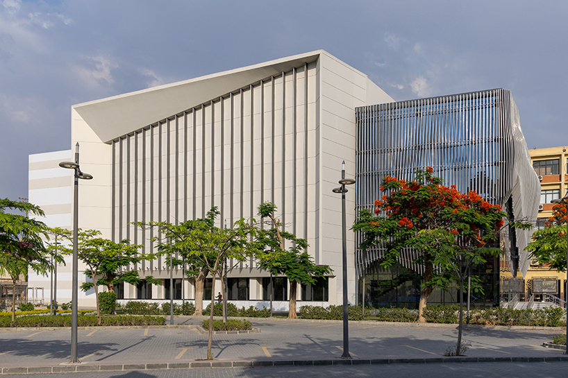undulating aluminum curtain facade drapes over ain shams university theater in egypt