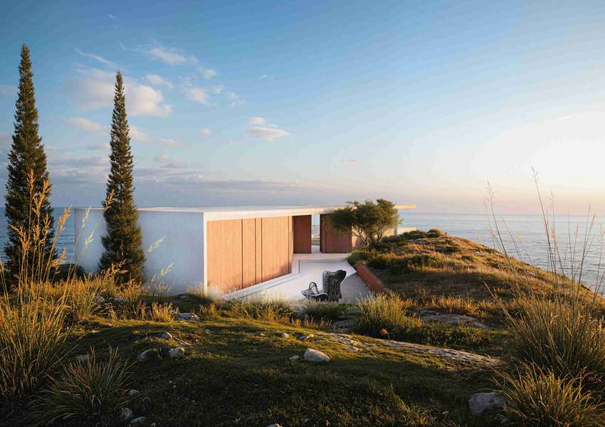 summer residence's sharp geometry emerges from greek seaside slope