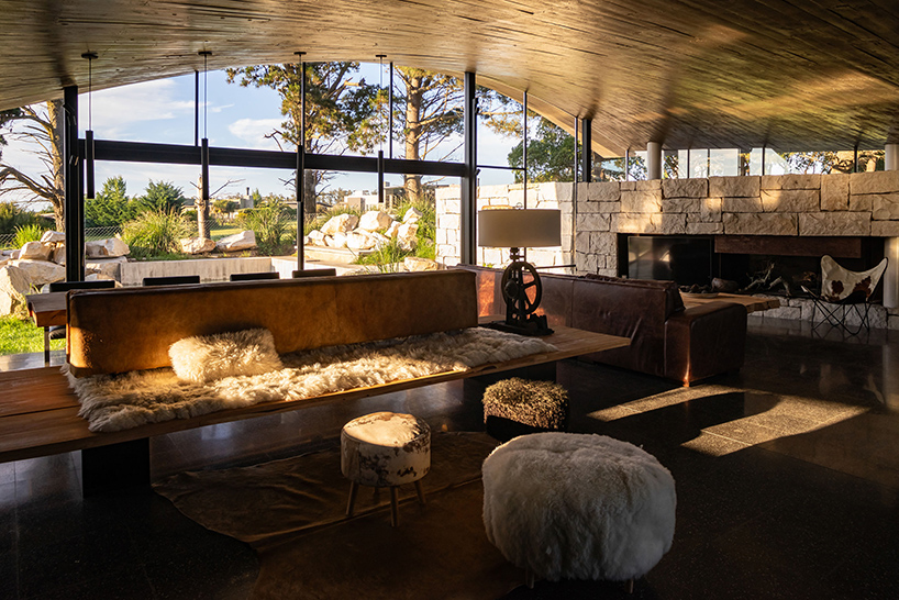 casa moro's green concrete mantle follows natural slope of forested terrain in buenos aires