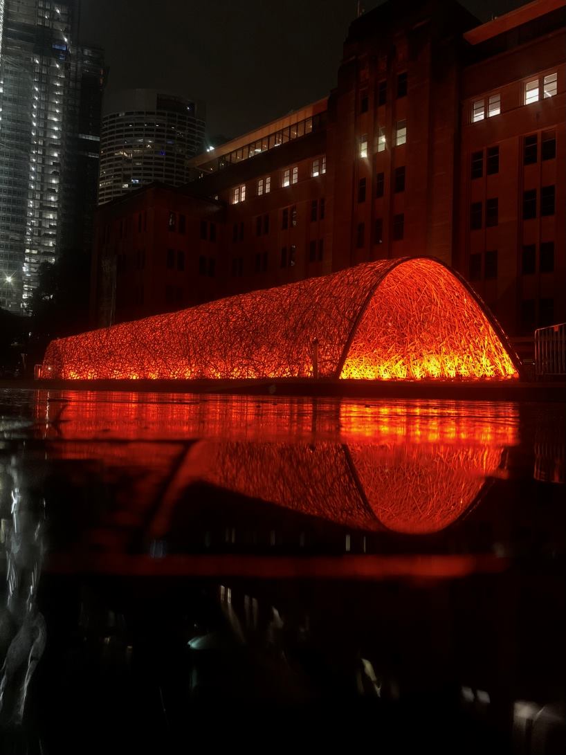 thousands of hand-split bamboo strands weave curved tunnel by cave urban in sydney