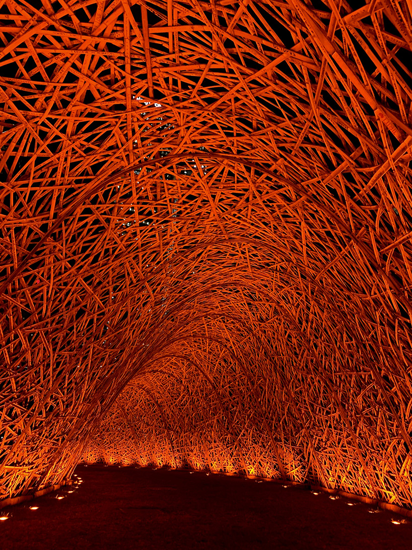thousands of hand-split bamboo strands weave curved tunnel by cave urban in sydney