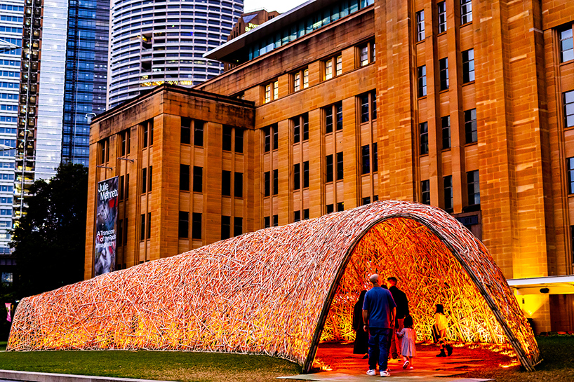 thousands of hand-split bamboo strands weave curved tunnel by cave urban in sydney