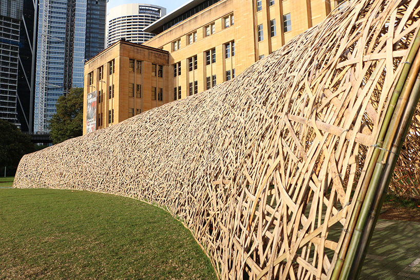 thousands of hand-split bamboo strands weave curved tunnel by cave urban in sydney