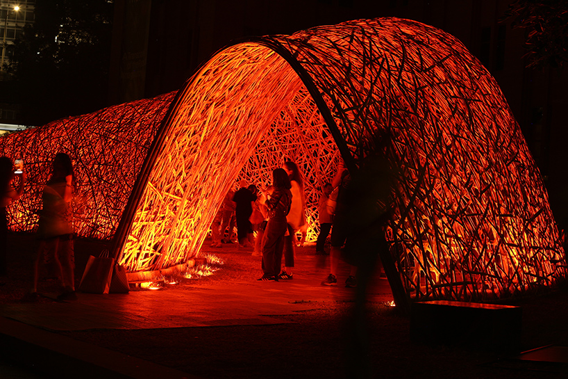 thousands of hand-split bamboo strands weave curved tunnel by cave urban in sydney
