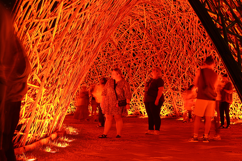 thousands of hand-split bamboo strands weave curved tunnel by cave urban in sydney