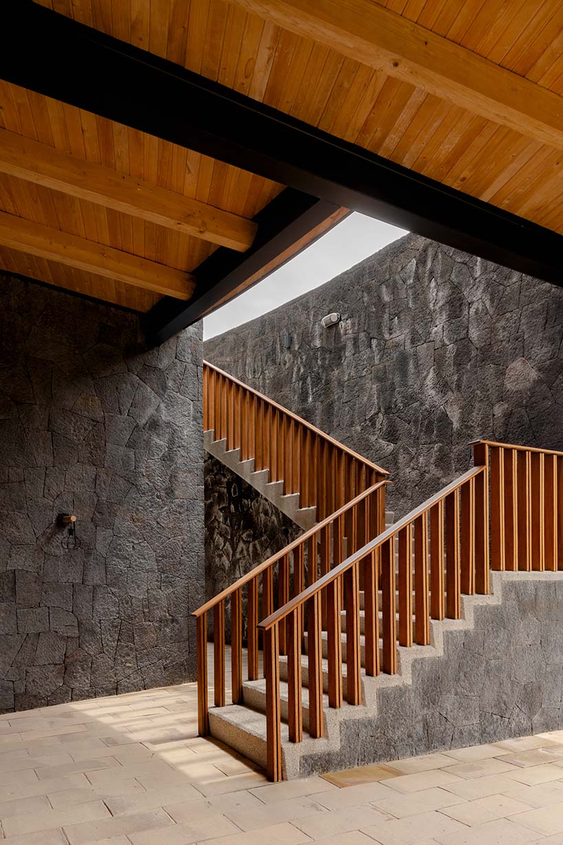 curved stone pavilion encloses circular reflecting pool for clubhouse in mexico