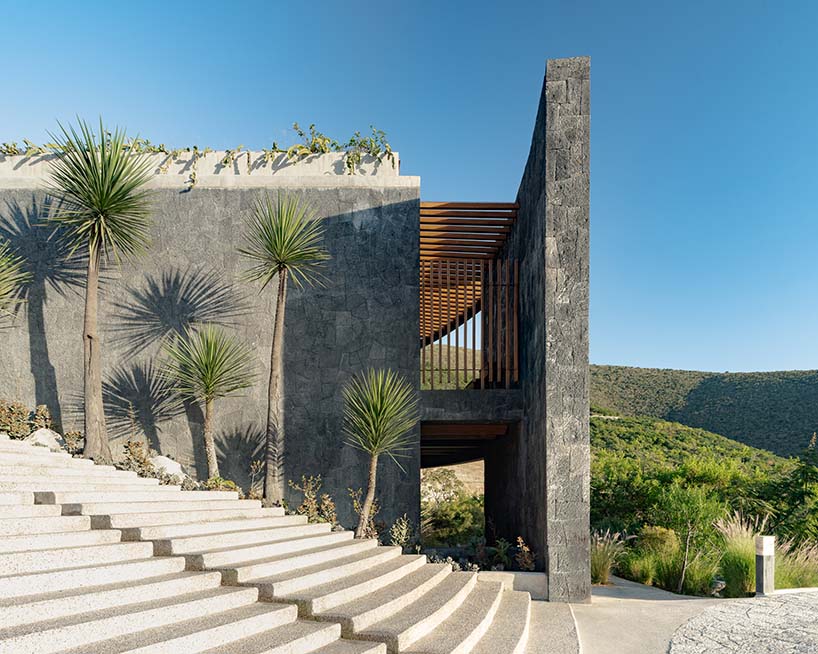 curved stone pavilion encloses circular reflecting pool for clubhouse in mexico