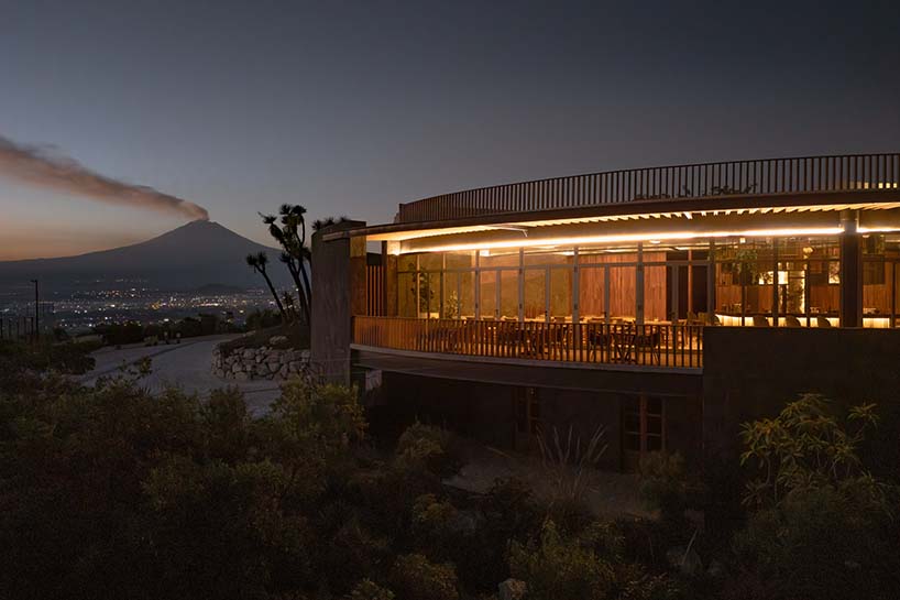 curved stone pavilion encloses circular reflecting pool for clubhouse in mexico