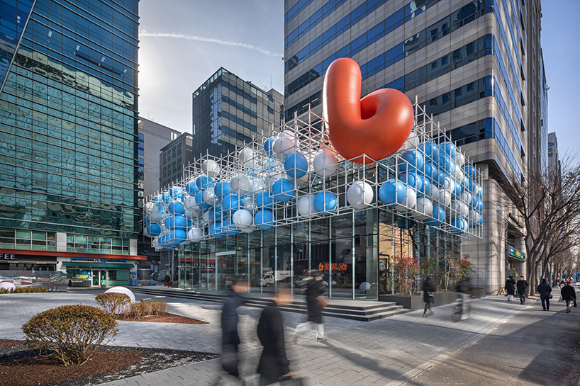 vibrant balloons nestle within metallic scaffolding atop seoul's playful urban hub by SSP