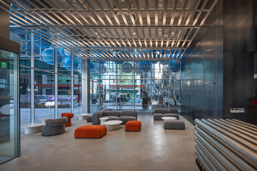 vibrant balloons nestle within metallic scaffolding atop seoul's playful urban hub by SSP