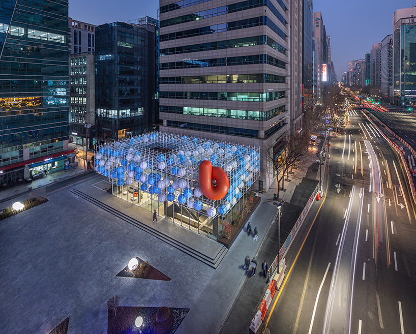 vibrant balloons nestle within metallic scaffolding atop seoul's playful urban hub by SSP