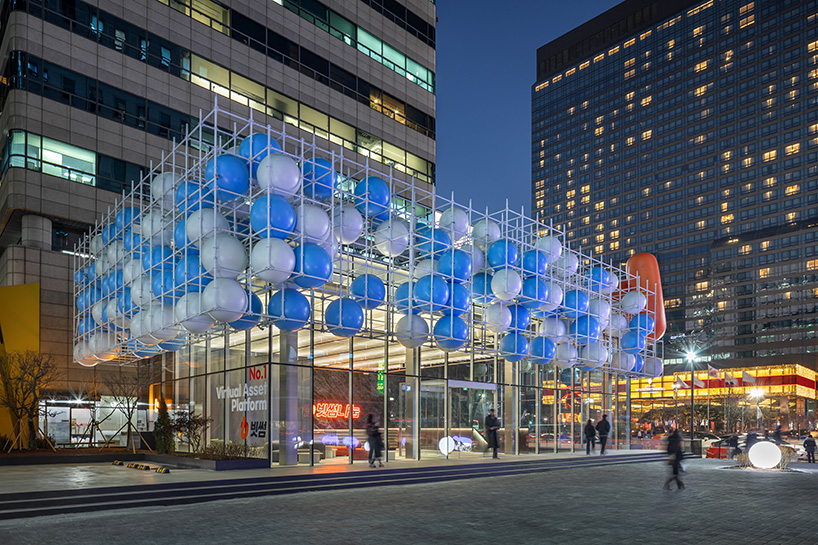 vibrant balloons nestle within metallic scaffolding atop seoul's playful urban hub by SSP