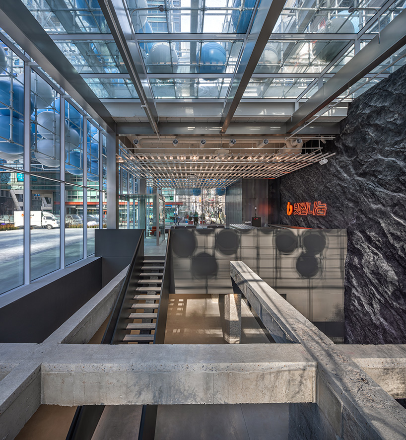 vibrant balloons nestle within metallic scaffolding atop seoul's playful urban hub by SSP