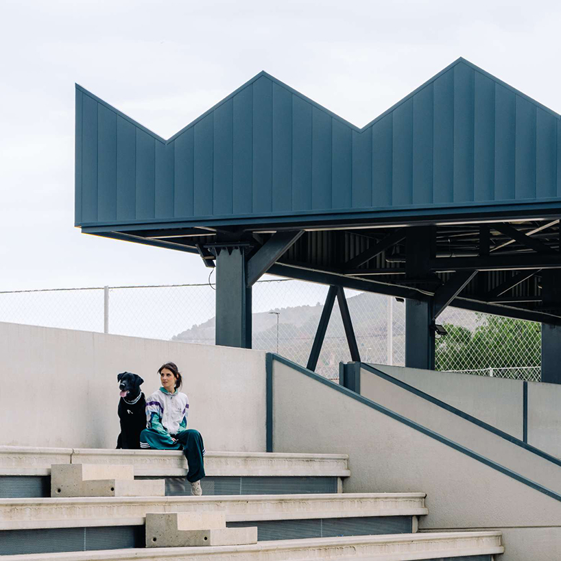 ribbed lime-green gateway and blue solar canopy reform municipal sports center in spain - 5