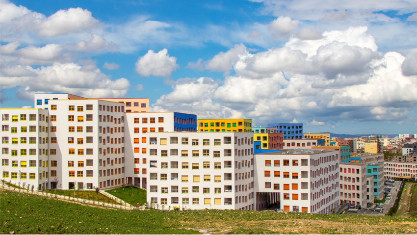 OMA's mangalem 21 masterplan steps checkerboard of homes down slope in tirana, albania