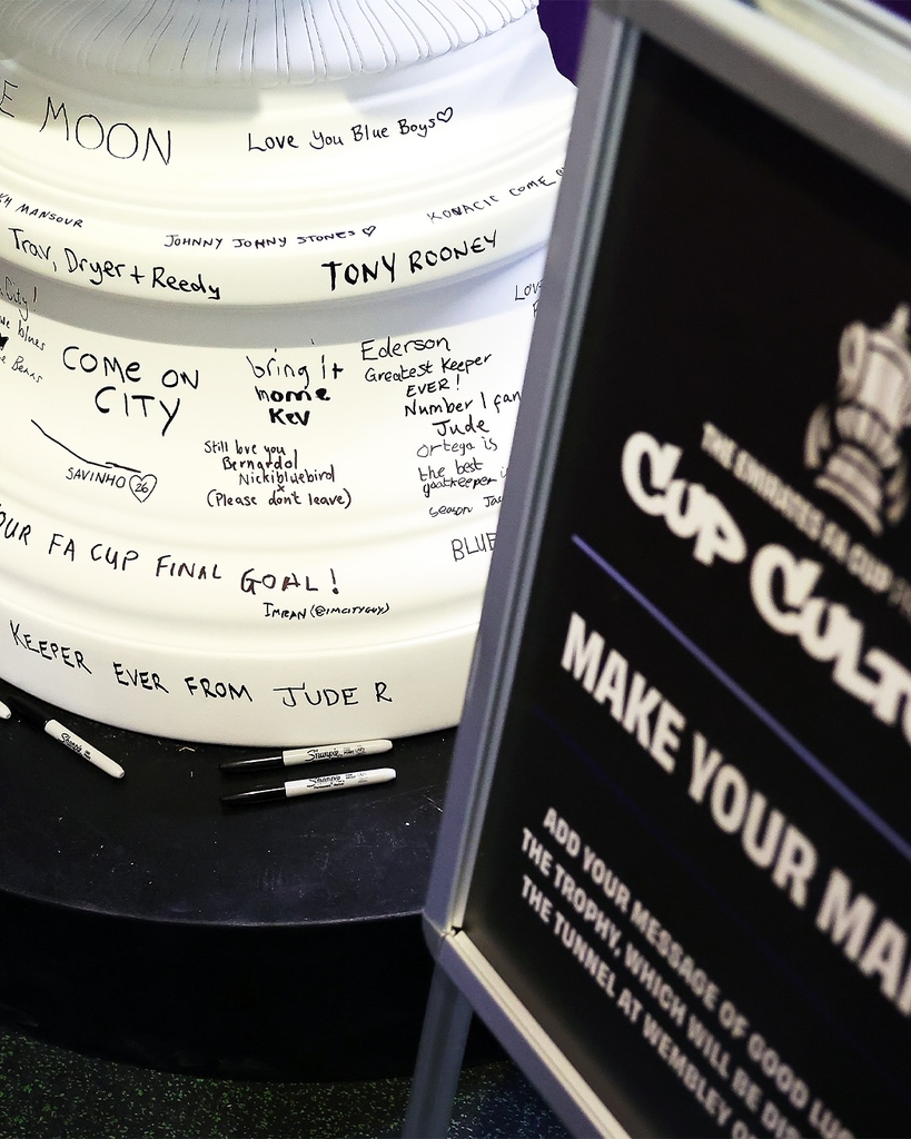 fans' inscriptions cover nigel VMU's six-foot sculptural cup trophy replicas for FA cup final