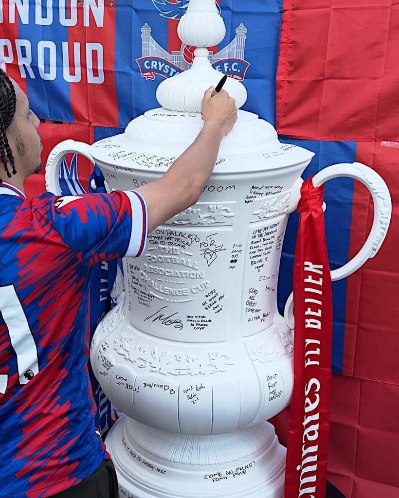 fans' inscriptions cover nigel VMU's six-foot sculptural cup trophy replicas for FA cup final