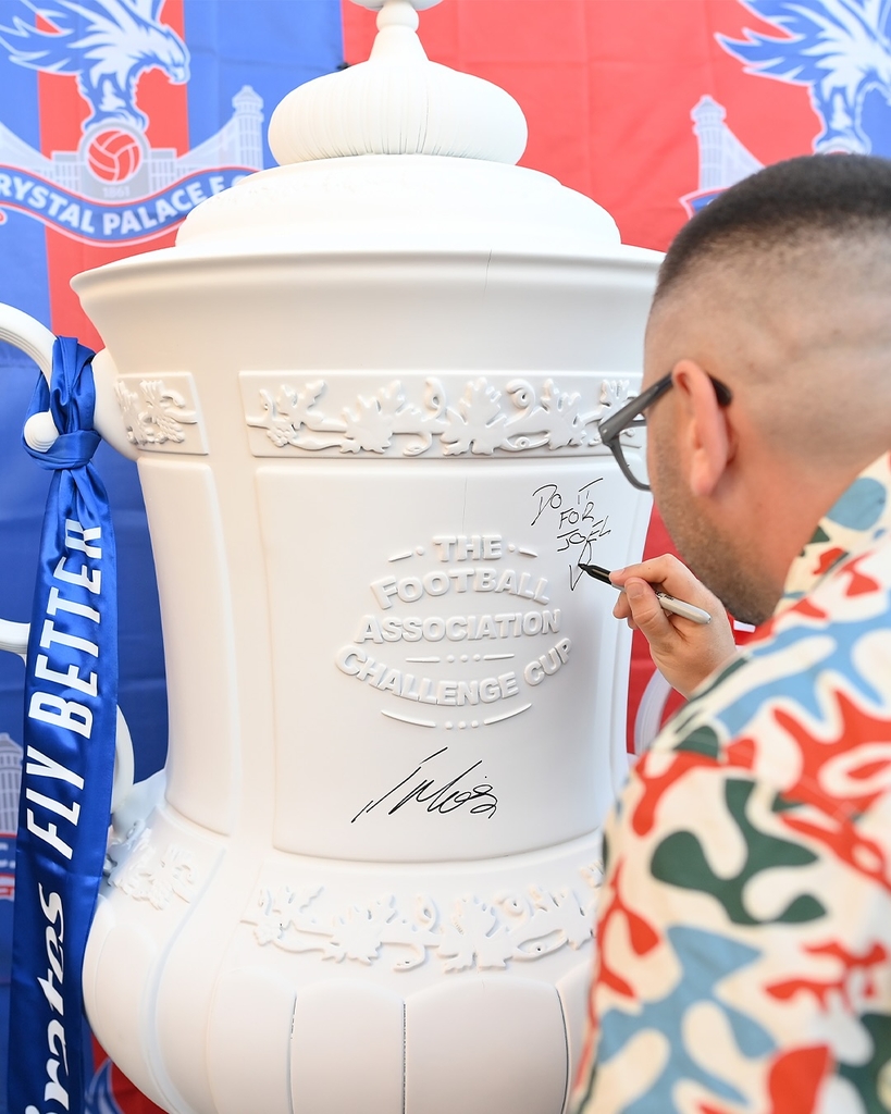 fans' inscriptions cover nigel VMU's six-foot sculptural cup trophy replicas for FA cup final