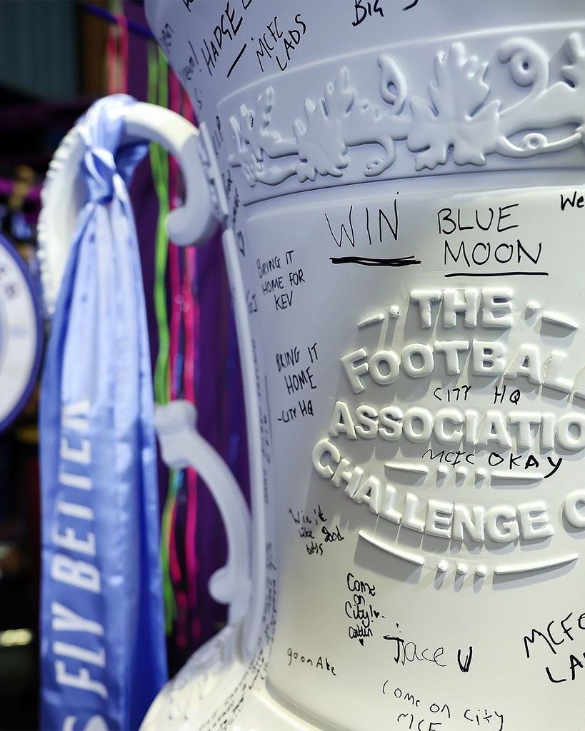 fans' inscriptions cover nigel VMU's six-foot sculptural cup trophy replicas for FA cup final