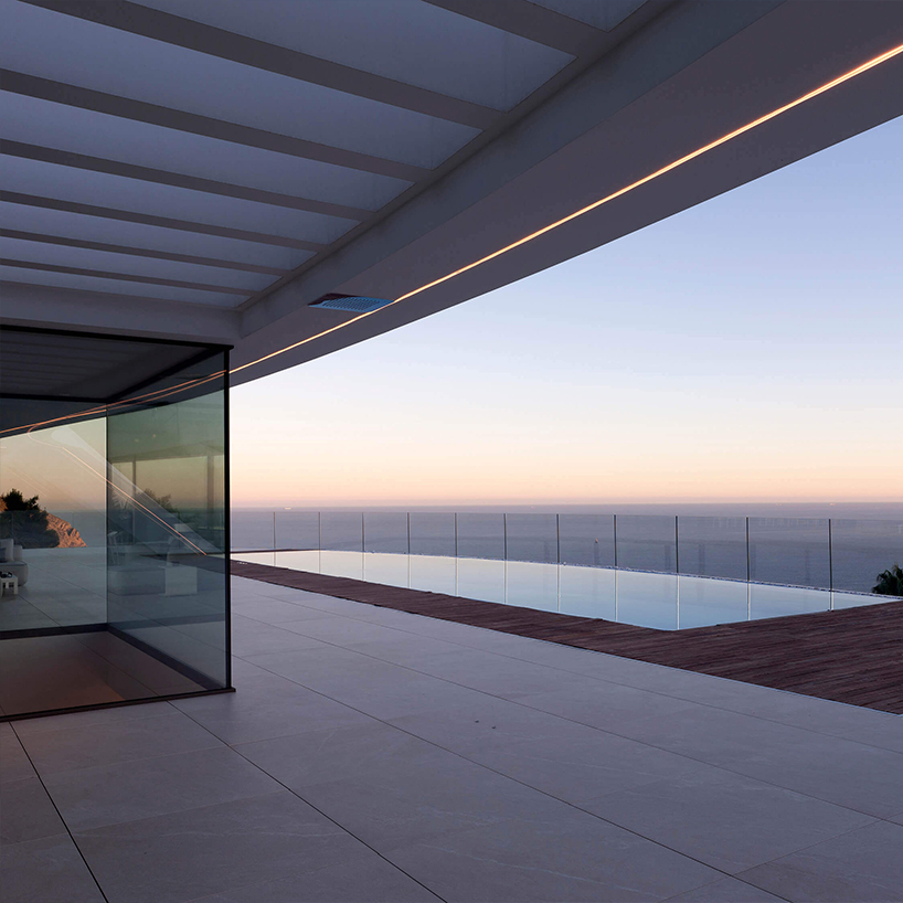 curved house's sinuous facade traces mountainous terrain in spain