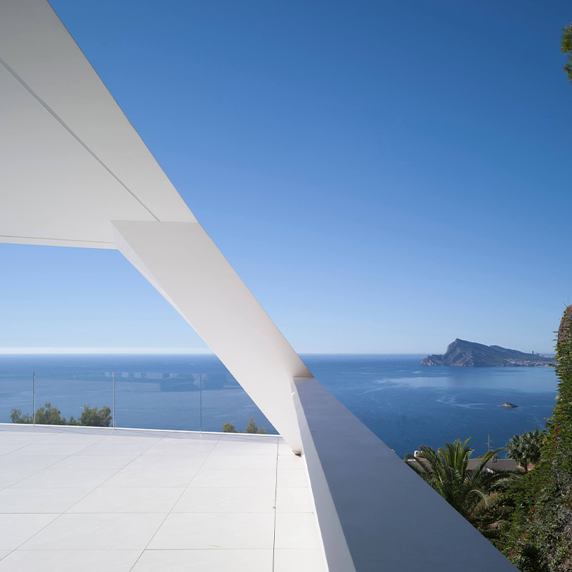 curved house's sinuous facade traces mountainous terrain in spain