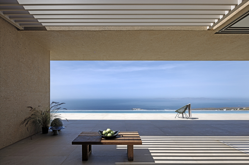 katerina valsamaki embeds subterranean house into hillside slot on tinos island, greece