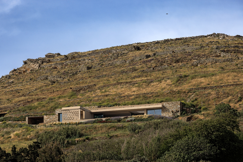 katerina valsamaki embeds subterranean house into hillside slot on tinos island, greece