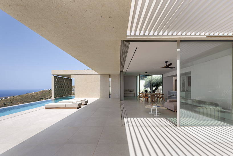 katerina valsamaki embeds subterranean house into hillside slot on tinos island, greece