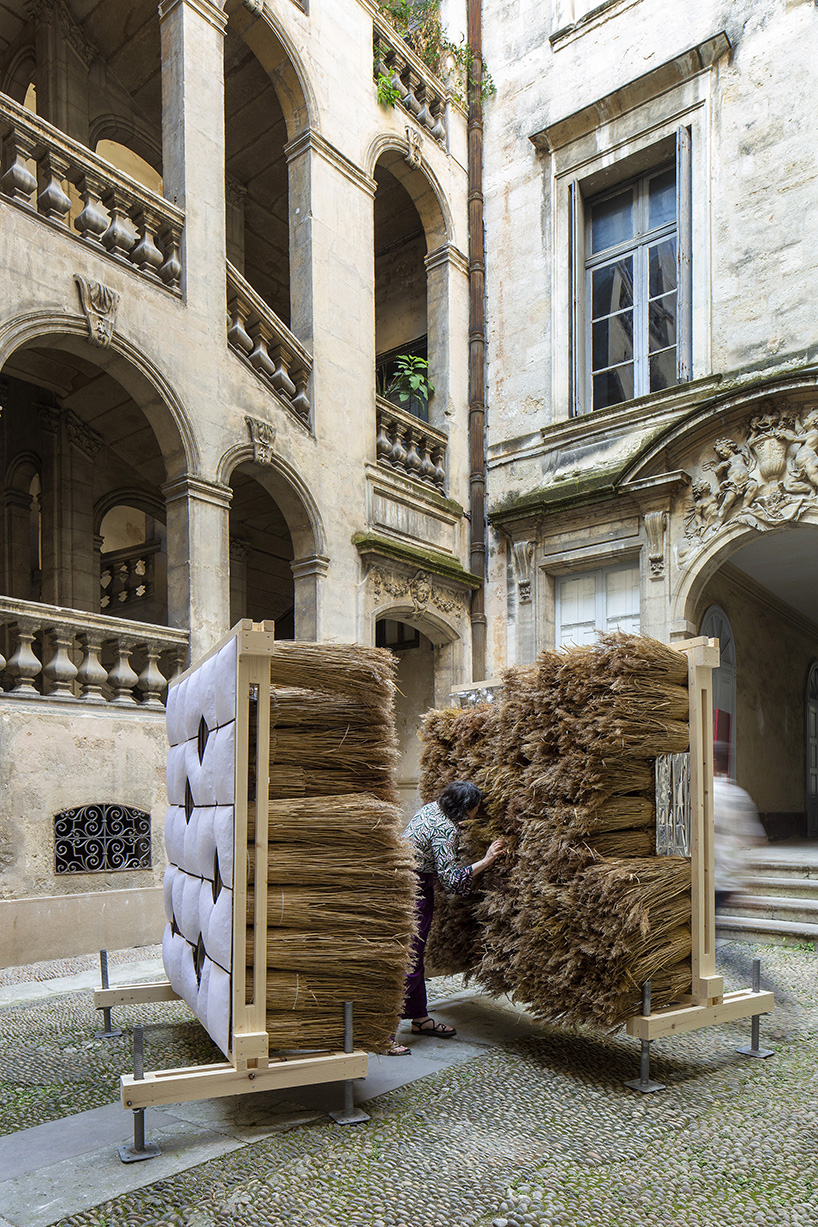 mirroring pillowed walls filled with reed grass compose sensory installation in montpellier