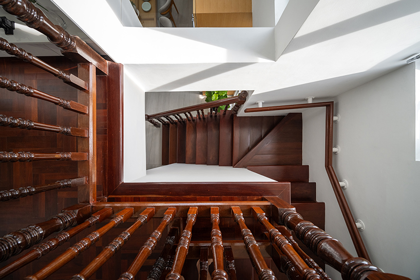 curved textile facades wrap reborn house in bangkok village emitting soft glow