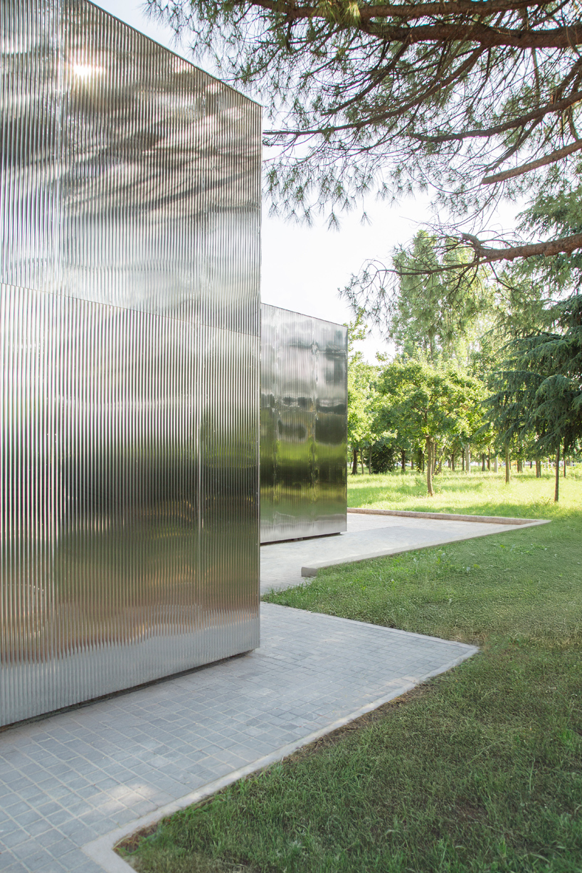 mirrored aluminum facade blurs distretto solidale social space into the italian landscape - 5