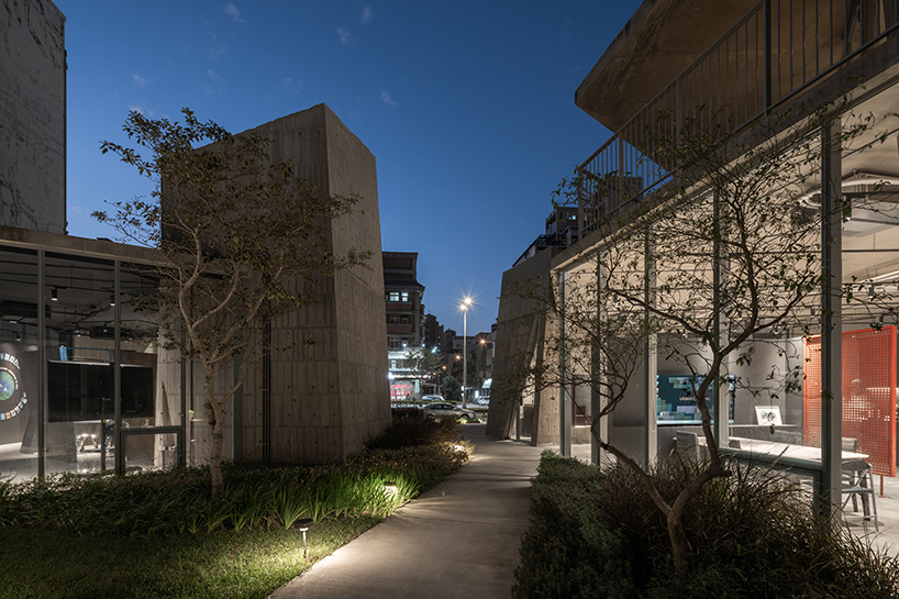 ten inclined concrete volumes outline stonehenge lodge real estate sales center in taiwan