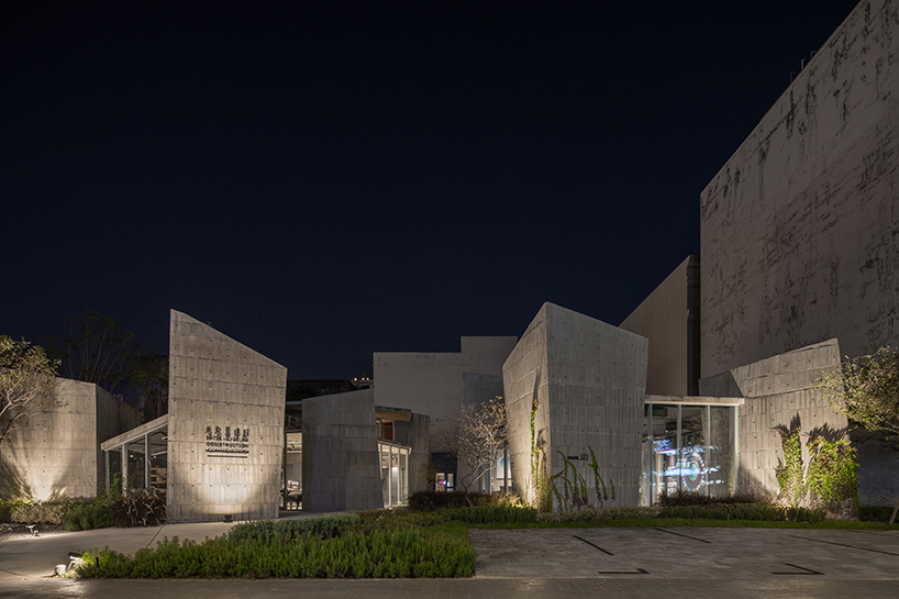 ten inclined concrete volumes outline stonehenge lodge real estate sales center in taiwan