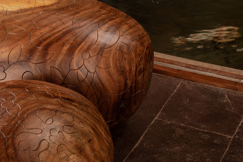 hybrid office-residence extends raw concrete balcony above recessed timber mass in india