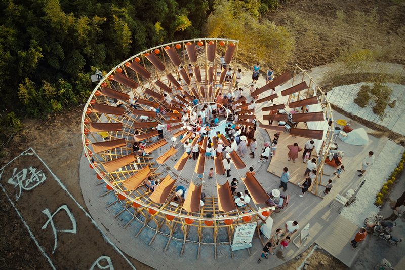 ladders turn into circular framework for climbing amphitheater in rural chinese town