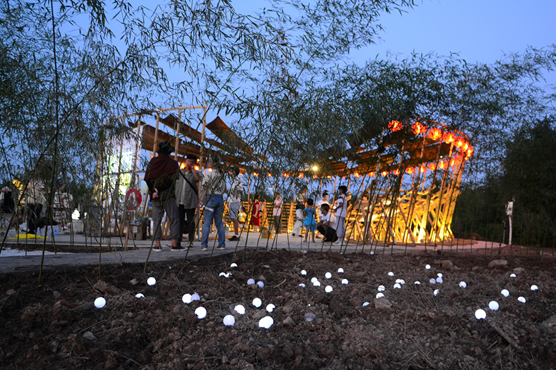 ladders turn into circular framework for climbing amphitheater in rural chinese town