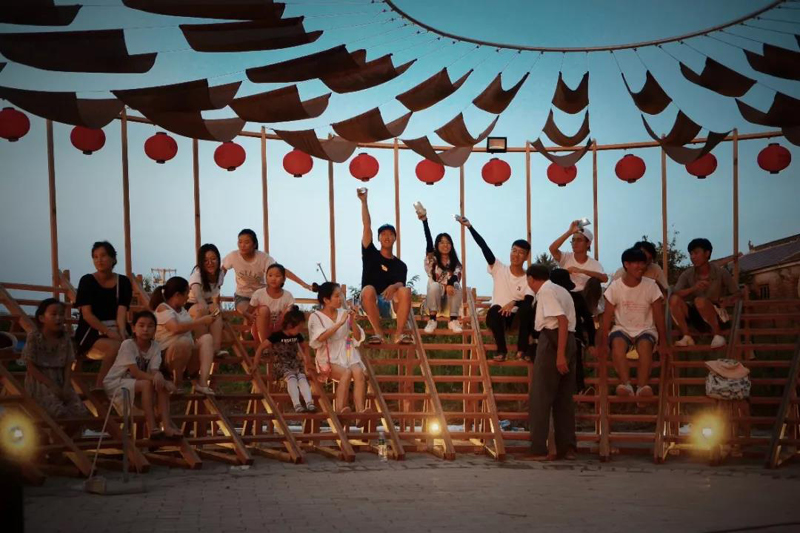 ladders turn into circular framework for climbing amphitheater in rural chinese town