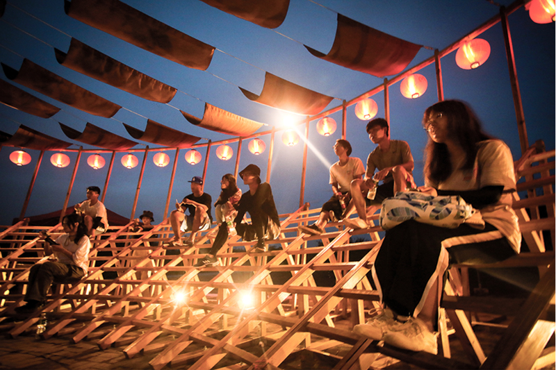ladders turn into circular framework for climbing amphitheater in rural chinese town