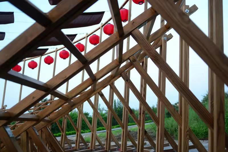 ladders turn into circular framework for climbing amphitheater in rural chinese town