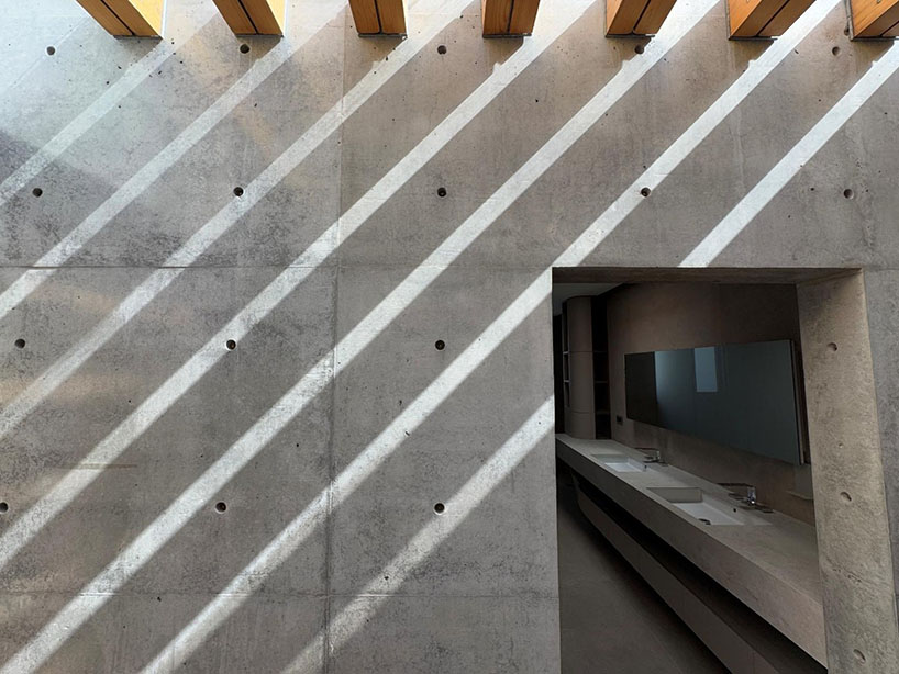 hyperbolic roof composed of curved timber slats tops concrete residence in taiwan