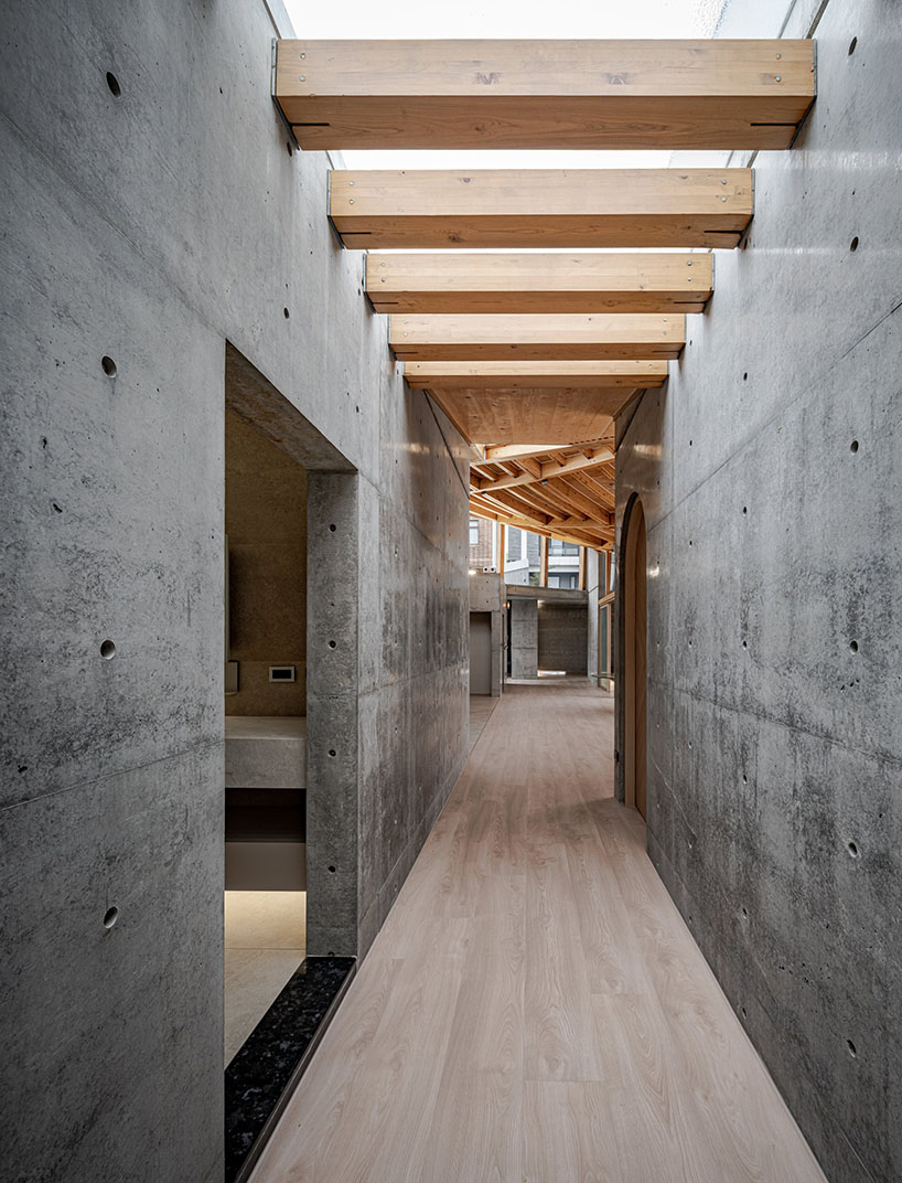hyperbolic roof composed of curved timber slats tops concrete residence in taiwan