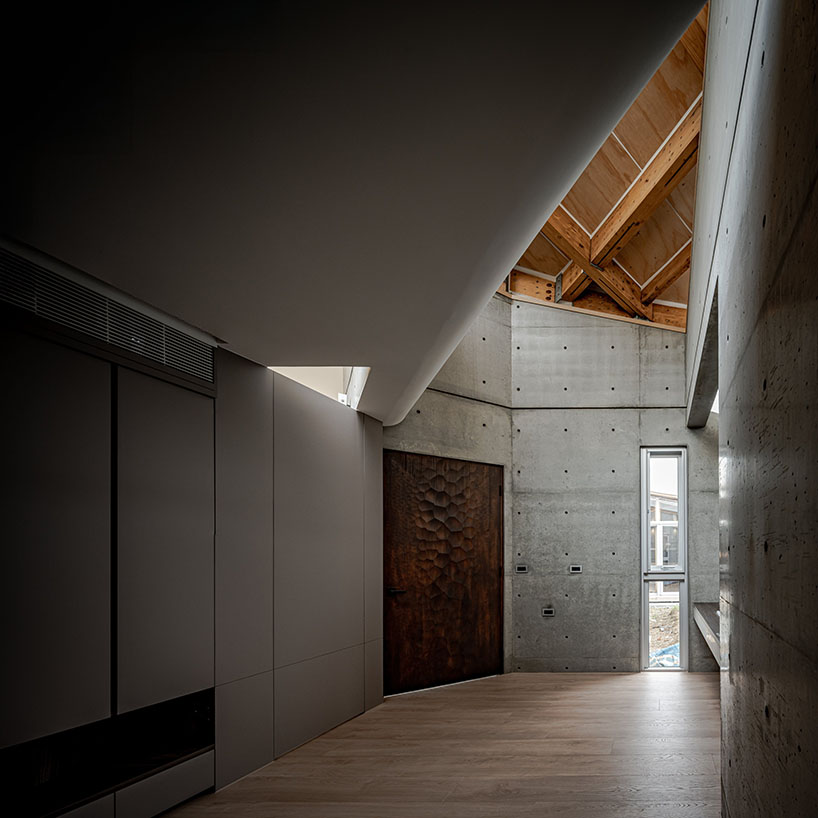 hyperbolic roof composed of curved timber slats tops concrete residence in taiwan