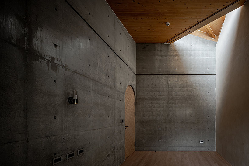 hyperbolic roof composed of curved timber slats tops concrete residence in taiwan
