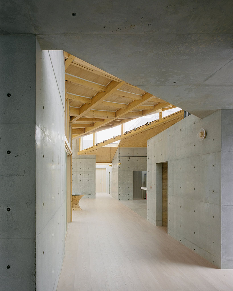 hyperbolic roof composed of curved timber slats tops concrete residence in taiwan