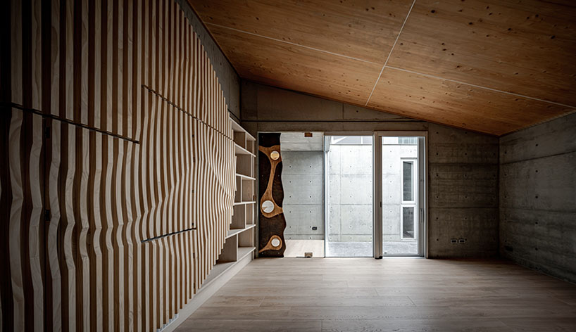 hyperbolic roof composed of curved timber slats tops concrete residence in taiwan